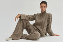 Load image into Gallery viewer, The Dune Sweater feels like a big hug! The gorgeous sand color is the perfect neutral staple, you&#39;ll reach for it over and over again. Pair it with our matching Dune Knit Pants to make it a set!

Soft ribbed knit fabric
Turtleneck
Drop shoulders
Long sleeves
Micro rib details at sleeve cuff and hem
Side Slits
Relaxed Fit
Wash cold with like colors
Model is 5&#39;7&quot; and wearing a Small
Pair it with our Dune Knit Pants to make it a set!